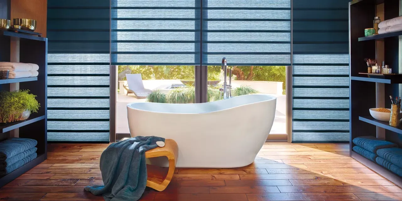 A bathroom with a tub and wooden floor
