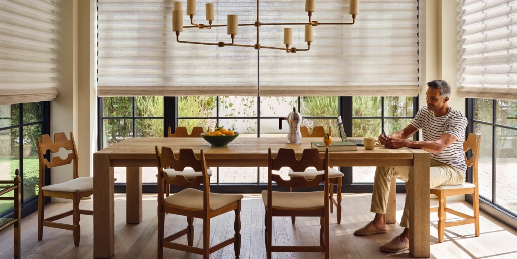 Dining room with Designer Banded Shades across large windows